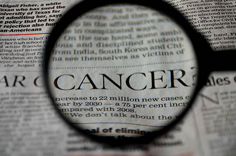loupe montrant en gros plan le mot cancer